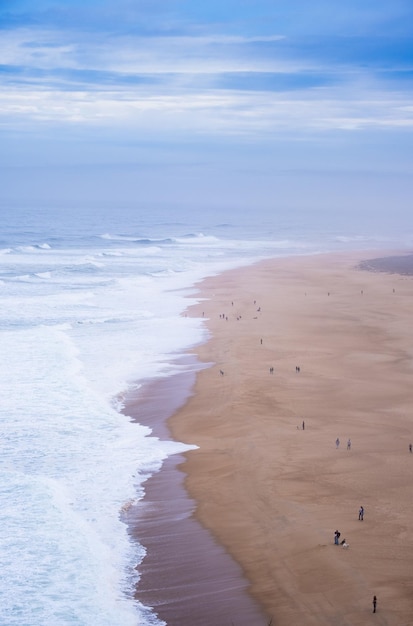 Niesamowita antena słoneczny seascape wybrzeża Oceanu Atlantyckiego Widok North Beach Praia do Norte Najbardziej znane miejsce gigantycznych rozbijających się fal dla surferów z całego świata Nazare Portugalia