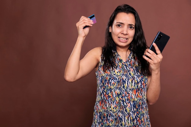 Niezadowolony Klient Dokonujący Zamówienia W Aplikacji Na Smartfona W Sklepie Internetowym, Zestresowana Indyjska Kobieta Mająca Problem Z Kasą W Witrynie E-commerce. Kobieta Kupująca Produkt W Sklepie Internetowym, Kłopoty Z Kartą Kredytową