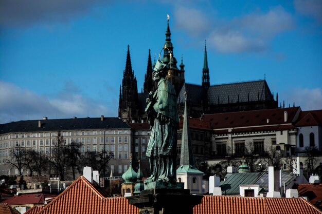 Niski kąt widoku męskiej posągu przeciwko kościołowi