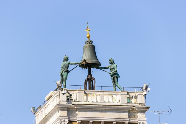 Zdjęcie niski kąt widoku posągu przeciwko budynkowi przeciwko jasnemu niebu.