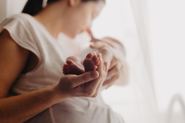 Zdjęcie nogi noworodka w rękach rodziców