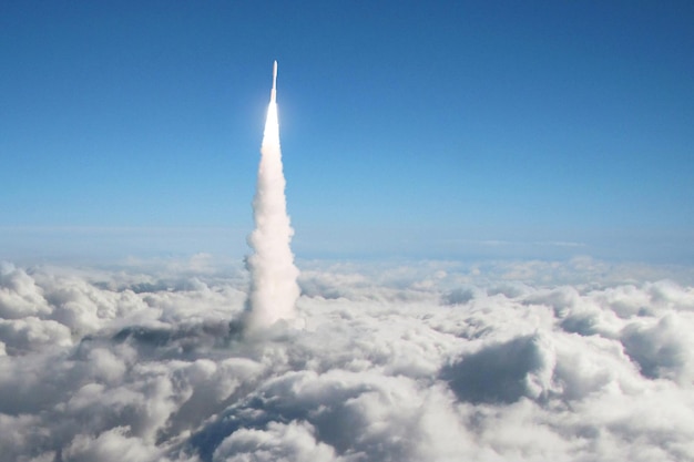 Zdjęcie nowa rakieta kosmiczna startuje przez chmury w przestrzeń kosmiczną start statku kosmicznego nad chmurami misja kosmiczna i nauka kreatywny pomysł rakiety