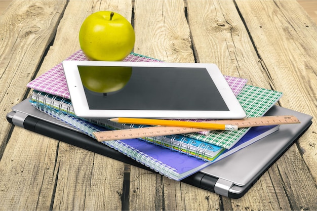 Zdjęcie nowoczesny cyfrowy tablet z jabłkiem i notebookami, laptop