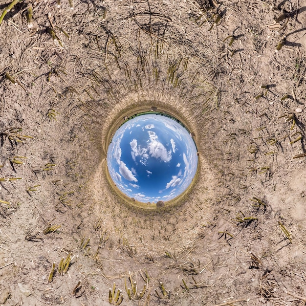 Odwrócenie niebieskiej malutkiej transformacji sferycznej panoramy 360 stopni Sferyczny abstrakcyjny widok z lotu ptaka na pole z niesamowitymi pięknymi chmurami Krzywizna przestrzeni