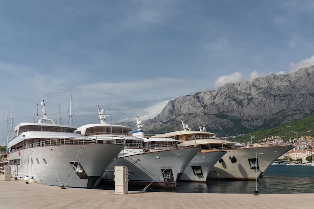 Ogromne wózki turystyczne w zatoce wielki plan W tle miasto Makarska Chorwacja Wysokie góry