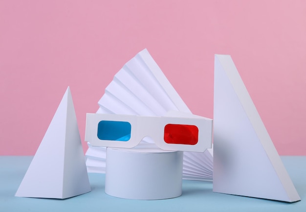 Okulary 3D i geometryczne kształty na niebiesko-różowym pastelowym tle Minimalna prezentacja Sztuka koncepcyjna