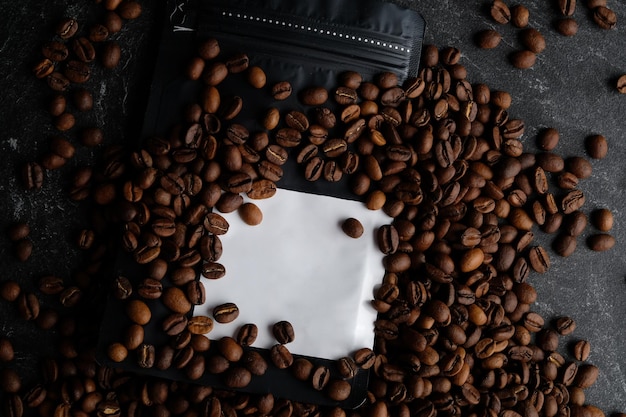 Opakowanie na czarną kawę z białą etykietą pokrytą palonymi ziarnami kawy