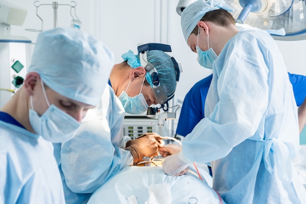 Operacja kręgosłupa. Grupa chirurgów w sali operacyjnej ze sprzętem chirurgicznym. Laminektomia