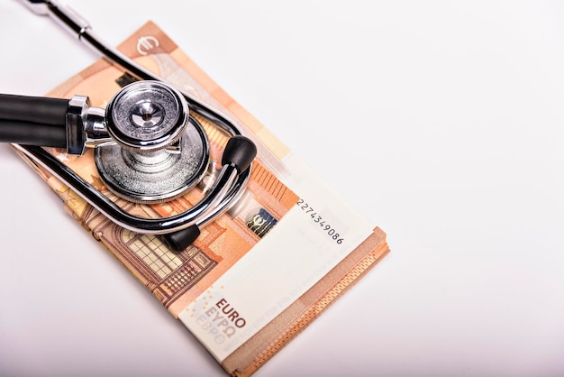 Opieka Zdrowotna Kosztuje Obraz Koncepcyjny Stetoskop I Stos Pieniędzy Na Symbol Wykresu Medycznego Kosztów Opieki Zdrowotnej Lub Ubezpieczenia Zdrowotnego Na Białym Tle