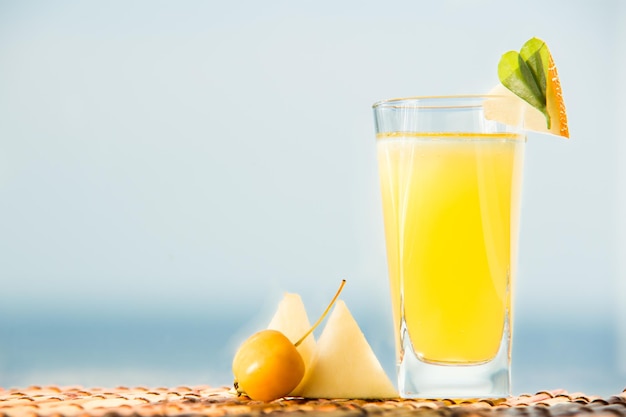 Organiczna Lemoniada Melonowa Z Wodą Mineralną. Koktajl Z Sokiem Z Melona I Lodem Z Morzem Na Tle.