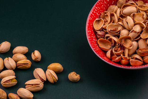 Organiczne Muszle Pistacjowe W Kwiecistej Misce Na Zielonej