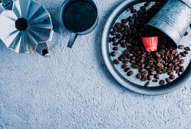 Organicznie kawowa kapsuła z kawowymi fasolami na kolorowym tle. Kontrast kolorów kopia przestrzeń