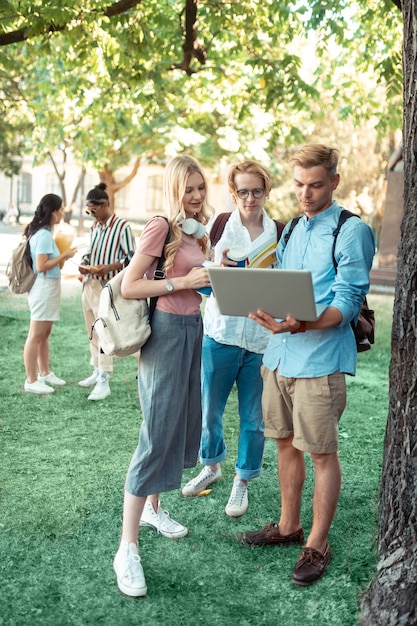 Ostrożni Studenci Stojący Pod Drzewem Na Dziedzińcu Uniwersytetu