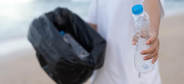 Oszczędzaj wodę Wolontariat zbiera śmieci na plaży, a plastikowe butelki trudno się rozkładają