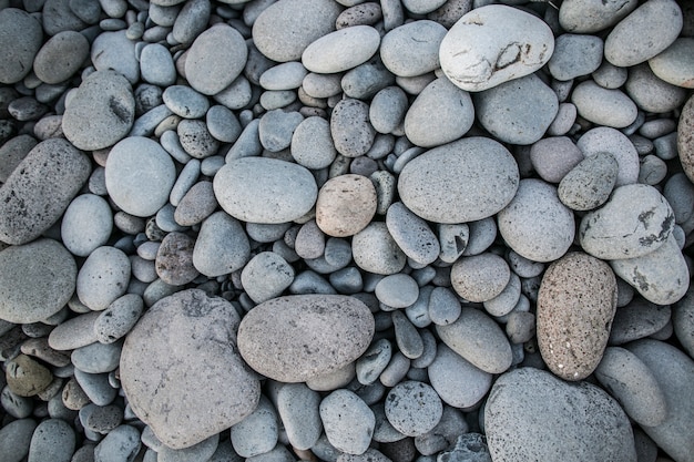 Otoczaka kamień na plażowym tekstury tle