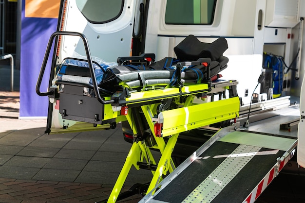 Zdjęcie otwarte drzwi samochodu ratunkowego z żółtym wózkiem do transportu pacjentów