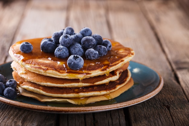 Pancake składany stos z płynnego miodu i świeżych jagód