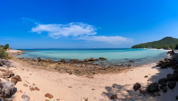 Panorama krajobraz piaszczysto-skalistej plaży z błękitnym morzem i bezchmurnym niebem z chmurami, relaks spokojny widok na seascape na plaży Thian, wyspa Koh Larn, Chonburi, Tajlandia