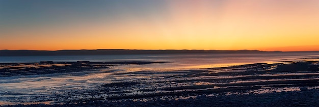 Panorama pięknego zachodu słońca nad skalistym wybrzeżem