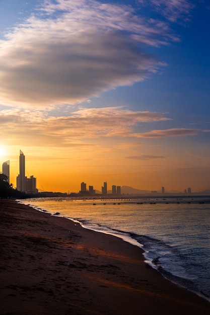 Panoramę miasta Pattaya na plaży o wschodzie słońca