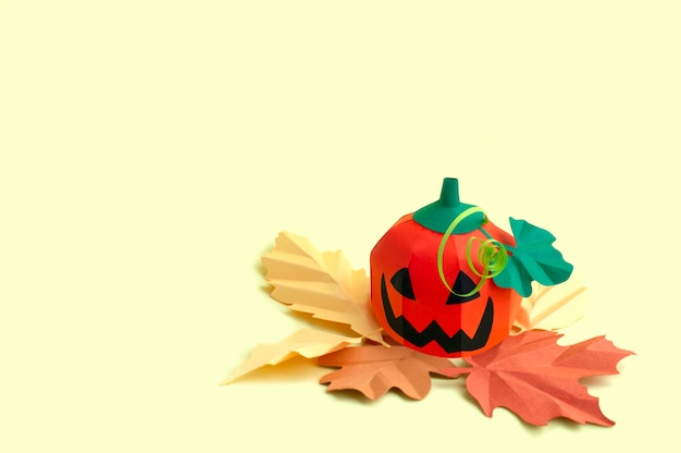 Papier wolumetryczny Jackolantern z jesiennymi liśćmi na żółtym tle do dekoracji Halloween