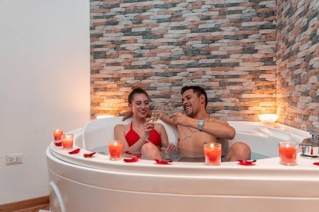 Para celebrująca romantyczny wieczór walentynkowy w hotelu z jacuzzi.