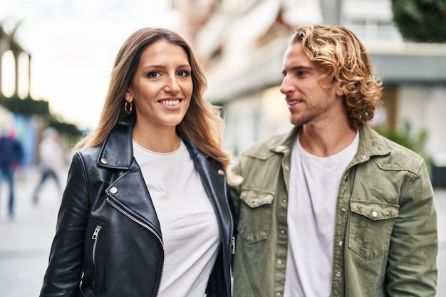 Para mężczyzna i kobieta uśmiechający się pewnie stojący razem na ulicy