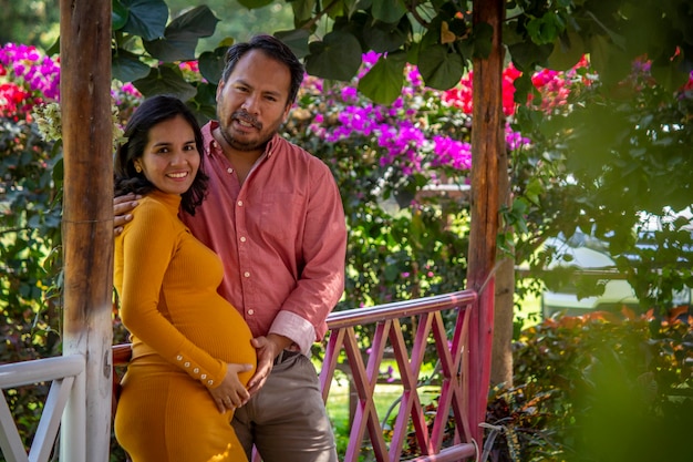Para Z Ameryki łacińskiej Czeka Na Dziecko W Pięknym Parku Pełnym Kwiatów