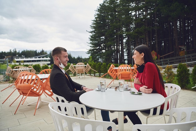 para z ochronną maską medyczną po przerwie na kawę w restauracji, nowa normalna koncepcja koronawirusa