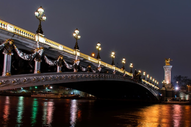 Paryż nocą, Pont Alexandre III, odbicie świateł w Sekwanie,