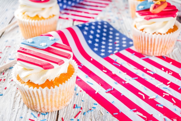 Patriotyczne babeczki USA nad flagami na stół z drewna