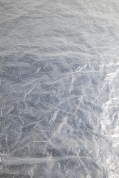 Zdjęcie pełne tło ramki z płaskiej, zmiętej, półprzezroczystej folii polietylenowej