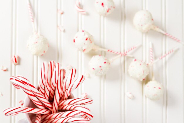 Peppermint chocolate cake pops zanurzony w białej czekoladzie i kawałkach trzciny cukrowej.