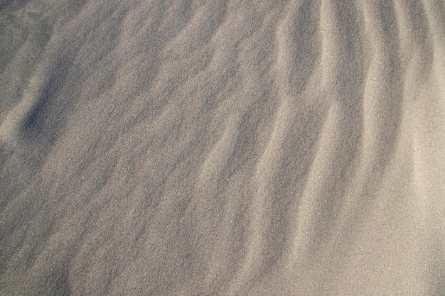 Piasek tekstura falisty piasek z teksturą w tle piasek z teksturą na plaży