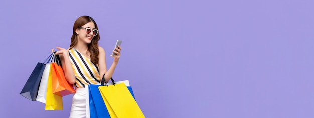Piękna Azjatycka kobieta robi zakupy online z telefonem komórkowym