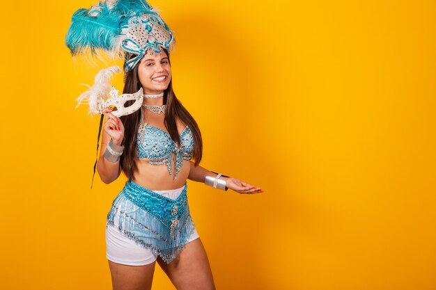 Piękna Brazylijska Kobieta W Niebiesko-białych Strojach Karnawałowych Z Koroną Z Piór I Maską Przedstawiająca Produkt Lub Tekst Na Bocznym Ogłoszeniu