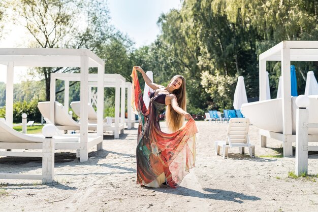 Piękna kobieta na plaży i pozowanie w miętowej sukience