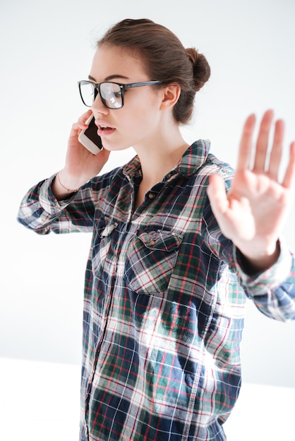 Zdjęcie piękna kobieta opowiada na telefonie komórkowym i pokazuje przerwa gest