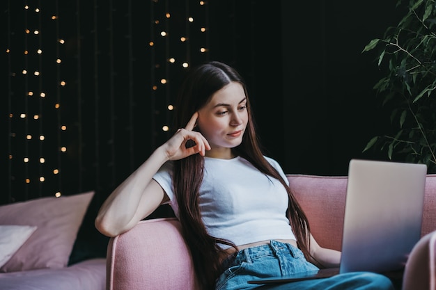 Piękna młoda kobieta za pomocą laptopa