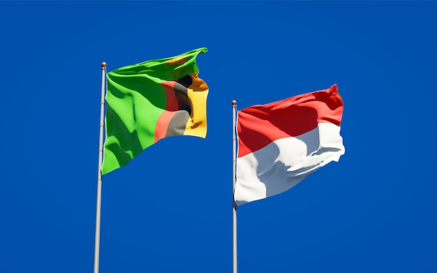 Piękne flagi państwowe Zambii i Indonezji razem na błękitnym niebie