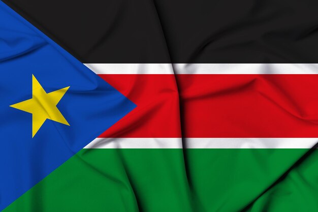 Pięknie machająca i paskowa tekstura tła flagi Sudanu Południowego z żywymi kolorami