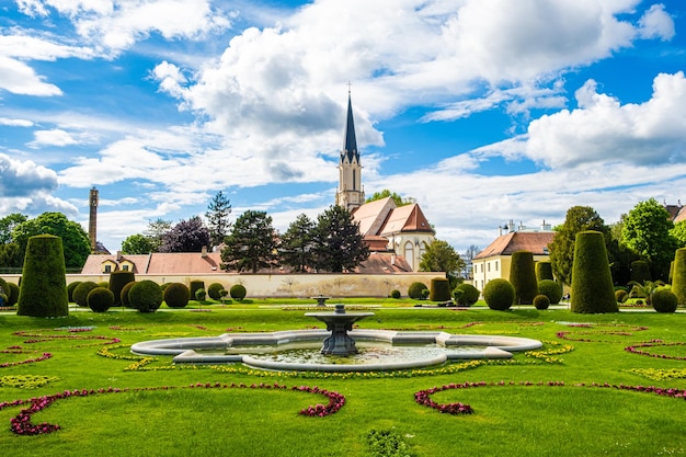Piękny europejski park i widok na fontannę i kościół w lecie