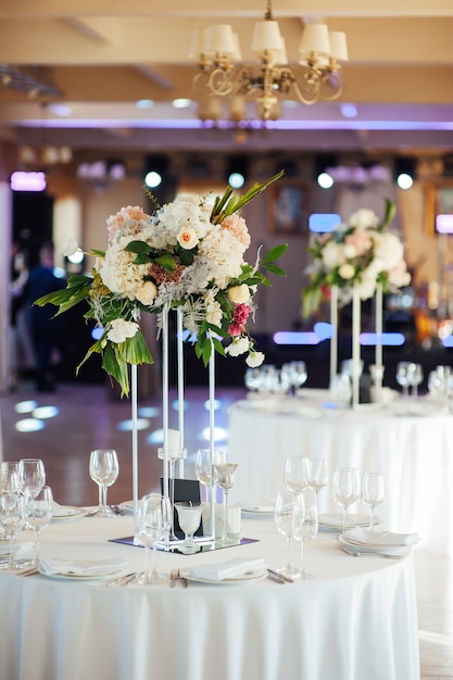 Piękny wazon z kwiatami na stole w luksusowej restauracji. Dekoracje ślubne.