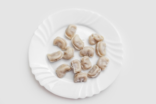 Pierogi z mięsem Pelmeni na białym talerzu dobre odżywianie zdrowa żywność płasko leżał zdjęcie