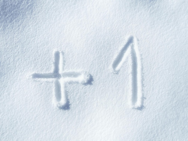 Zdjęcie pisanie na śniegu i liczby z dodawaniem plus i czcionka na lodzie i symbole na zewnątrz w zimie tekst matematyki i praktyki z arytmetyką dla wiedzy i edukacji z zimną pogodą i równaniem