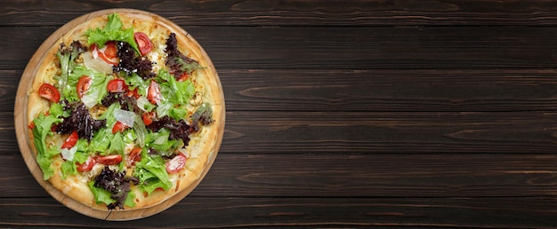 Zdjęcie pizza z pieczarkami, parmezanem i ziołami na drewnianej desce baner