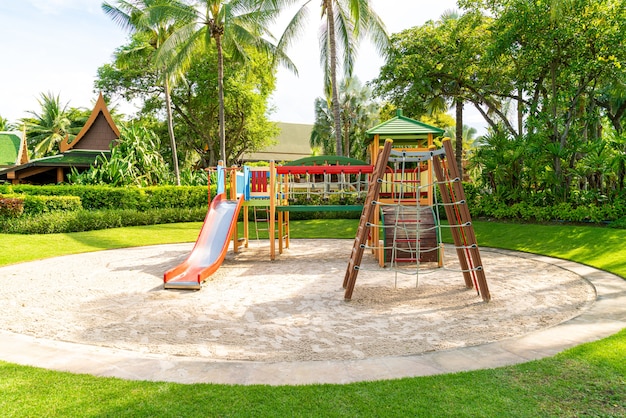 Plac zabaw dla dzieci, suwak umieszczony na piasku.