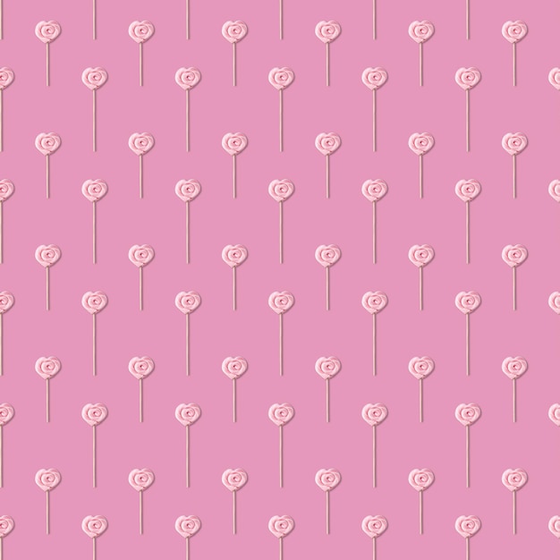 Płynny wzór z różowym lizakiem w formie serca na patyku na pastelowym różowym tle
