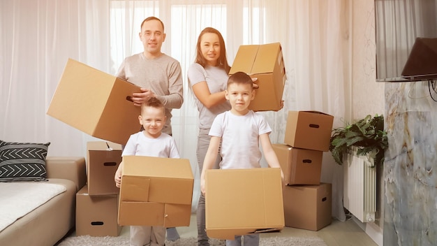 Podekscytowana rodzina wprowadza się do nowego mieszkania, niosąc paczki