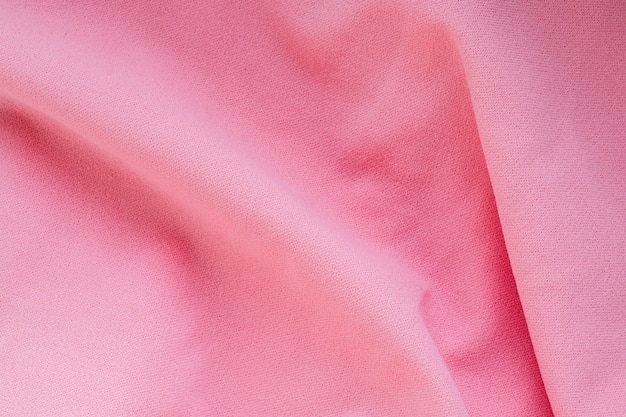 Pojęcia dotyczące tekstyliów i tekstur. Zbliżenie różowa falista tło tkanina.